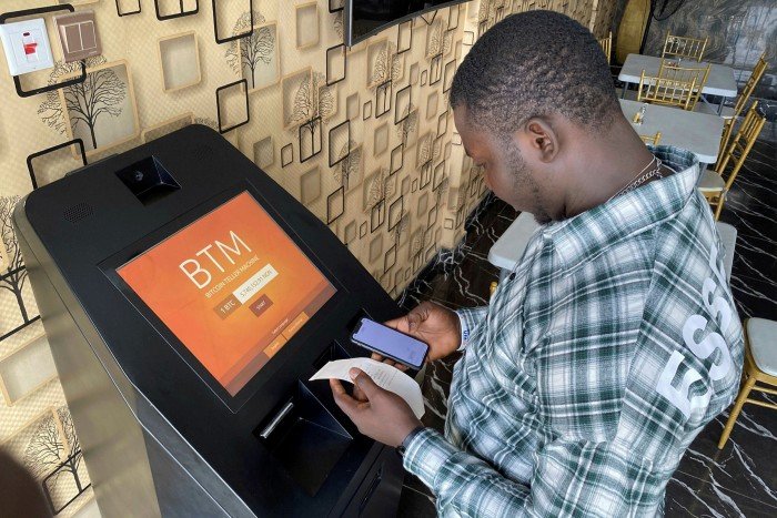 A buys bitcoins at a teller machine in Lagos. Some observers, including the Central Bank of Nigeria, are concerned that inexperienced investors could lose their meagre savings gambling on a highly speculative asset