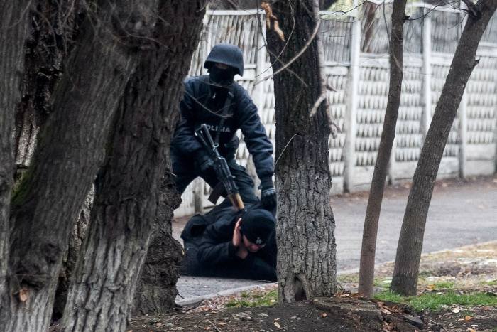 An armed riot police officer holds a protester after Saturday’s clashes in Almaty, Kazakhstan